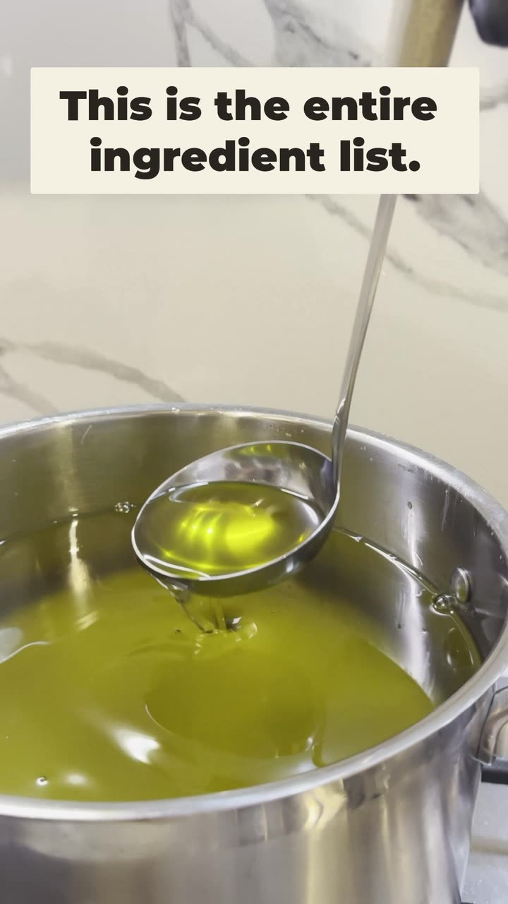 Rendered grass-fed tallow lifted from the pot on a ladle